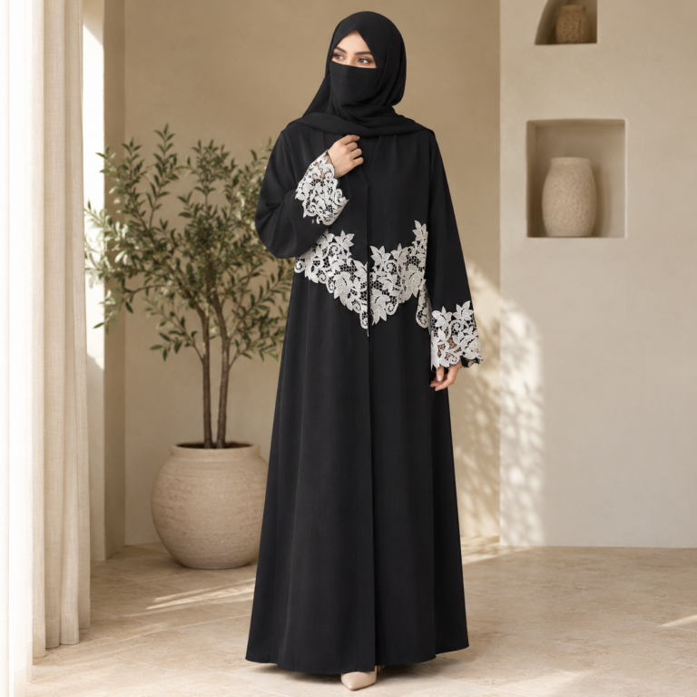 Woman wearing black and white cutwork abaya with lace work on sleeves and matching hijab for modest wear